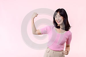 Portrait young asian woman proud and confident showing strong muscle strength arms flexed posing, feels about her success