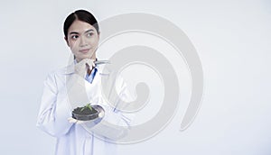 Portrait of young Asian woman scientist in white uniform working in laboratory