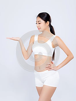 Portrait young asian woman smiling beautiful body diet with fit presenting something empty copy space on the hand isolated