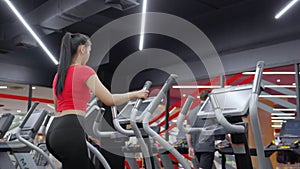 Portrait young asian woman walking on treadmill in fitness gym, cardio exercise, sport and training, health and wellness.