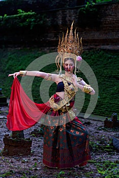 Portrait of a young Asian woman wearing an Apsara dress with ghost face makeup