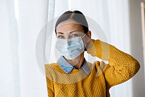 Portrait of young Asian woman,  wearing a medical surgical disposabhttpsle face mask to prevent infection