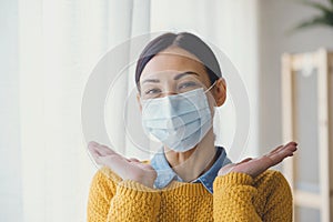 Portrait of young Asian woman,  wearing a medical surgical disposabhttpsle face mask to prevent infection