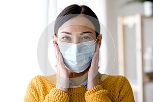 Portrait of young Asian woman,  wearing a medical surgical disposabhttpsle face mask to prevent infection photo