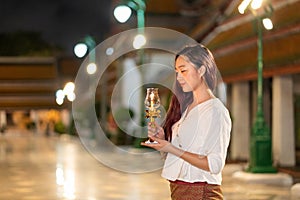 portrait young asian woman wearing traditional dress of Thailand holding candle for pray and meditation, Buddhism Candle Ceremony