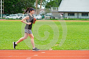 Portrait of young athlete runner woman running in the running track in stadium.