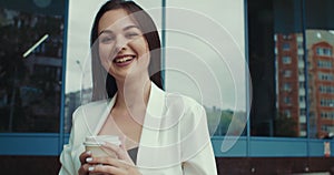 Portrait of young attractive businesswoman drinking coffee