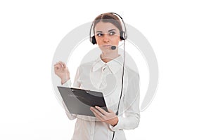 Portrait of young attractive call center worker girl with headphones and microphone posing isolated on white background