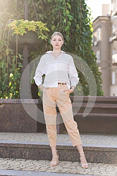 Portrait of a young and attractive Caucasian woman in casual clothes while walking around the city. The concept of fashion, style