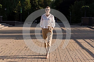 Portrait of a young and attractive Caucasian woman in casual clothes while walking around the city. The concept of fashion, style