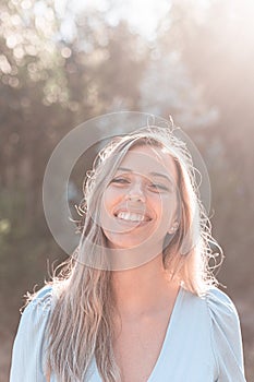 Portrait of a young and attractive caucasian woman near a forest