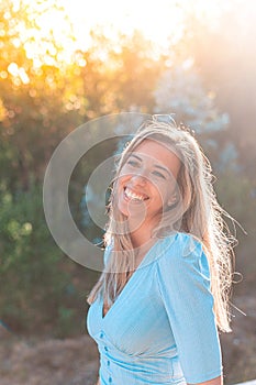 Portrait of a young and attractive caucasian woman near a forest