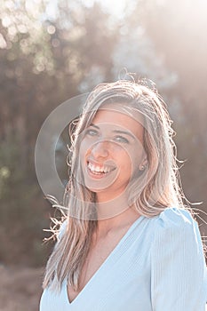 Portrait of a young and attractive caucasian woman near a forest