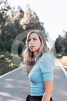 Portrait of a young and attractive caucasian woman near a forest