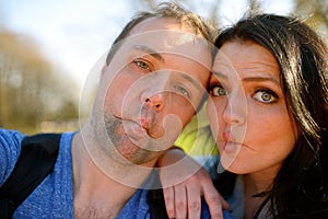 Portrait of young attractive couple having emotional fun tomfoolery together.