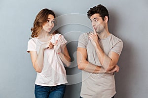 Portrait of a young attractive couple showing peace gesture