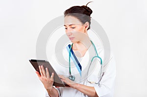 Portrait of young attractive doctor, surgeon, nurse with stethoscope and tablet