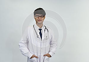 Portrait young attractive doctor in uniform with  stethoscope standing isolated on white background