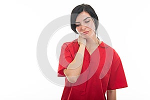 Portrait of young attractive female nurse holding neck like hurting