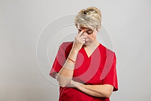 Portrait of young attractive female nurse making problem gesture