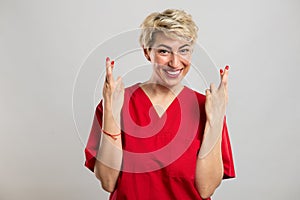 Portrait of young attractive female nurse showing double fingers crossed