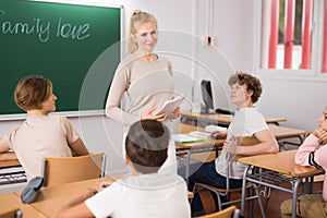 Female teacher giving lesson to children in school