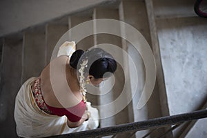 Portrait of an young and attractive Indian woman in white traditional wear for the celebration of Onam/Pongal