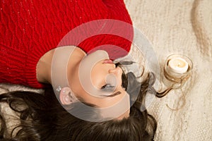 Portrait of an young attractive lying woman with long brown hair