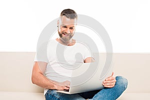 portrait of young attractive man using laptop,