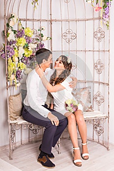 Portrait of young attractive romantic couple hugging and kissing. Love and relationships lifestyle, interior bedroom.