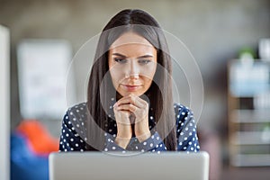 Portrait of young attractive serious focused thoughtful minded businesswoman thinking look in laptop work at office