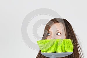 Portrait of young attractive smiling brunette caucasian housewife on white background. Beautiful housekeeper woman