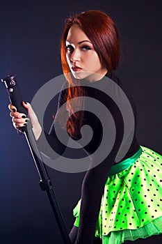 Portrait of a young attractive woman dancing with a stick