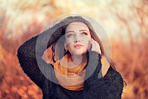 Portrait of an young attractive woman with long brown hair and b