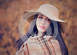 Portrait of an young attractive woman with long brown hair and b