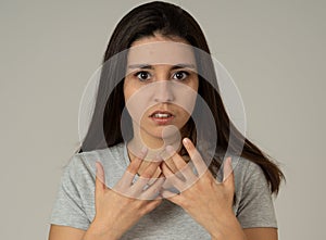 Portrait of a young attractive woman looking scared and shocked. Human expressions and emotions