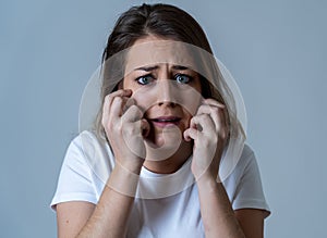 Portrait of a young attractive woman looking scared and shocked.Human expressions and emotions