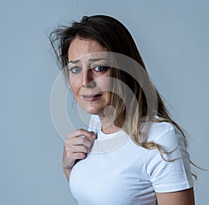 Portrait of a young attractive woman looking scared and shocked.Human expressions and emotions