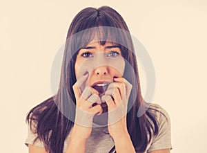 Portrait of a young attractive woman looking scared and shocked.Human expressions and emotions