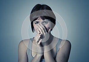 Portrait of a young attractive woman looking scared and shocked.Human expressions and emotions