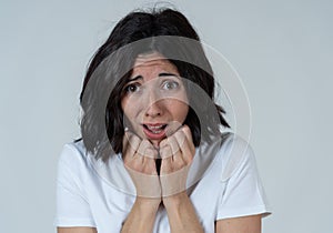 Portrait of a young attractive woman looking scared and shocked.Human expressions and emotions