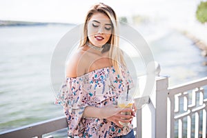 Portrait of young woman sitting on promenade and sight seeings as background photo