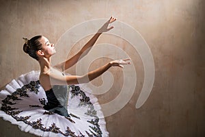 Portrait of a young ballerina in white tutu posing