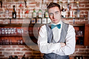 Portrait of young bartender in bar or nightclub