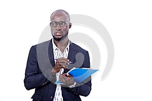 Portrait of a young bearded businessman holding a folder, thoughtful