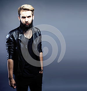 Portrait of young bearded hipster guy on gray dark background close up, brutal modern man, lifestyle people concept