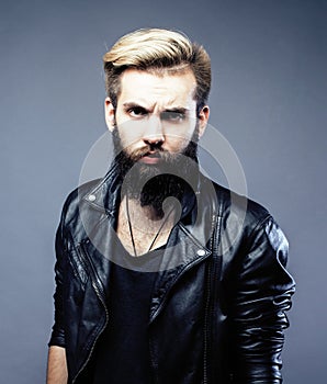 Portrait of young bearded hipster guy on gray dark background close up, brutal modern man, lifestyle people concept