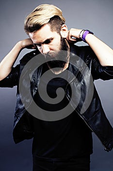 Portrait of young bearded hipster guy on gray dark background close up, brutal modern man, lifestyle people concept