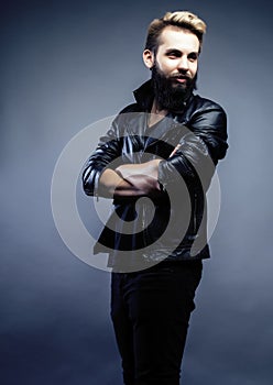 Portrait of young bearded hipster guy on gray dark background close up, brutal modern man, lifestyle people concept