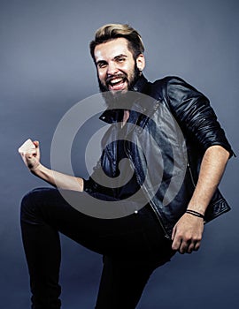 Portrait of young bearded hipster guy on gray dark background close up, brutal modern man, lifestyle people concept